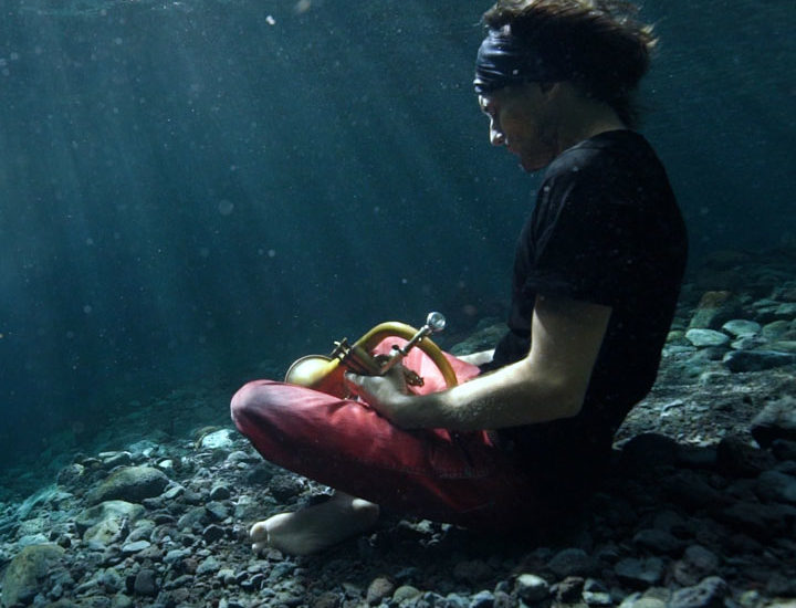 flugelhorn player sitting underwater